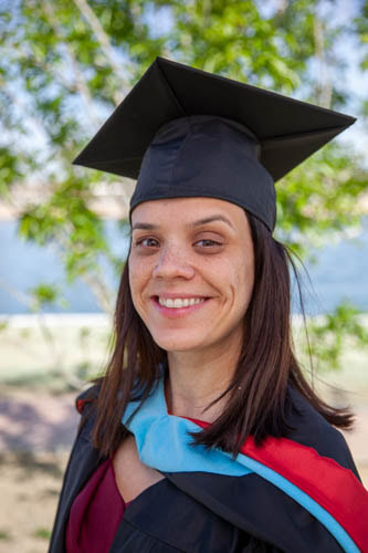 A person wearing a hat and smiling at the camera