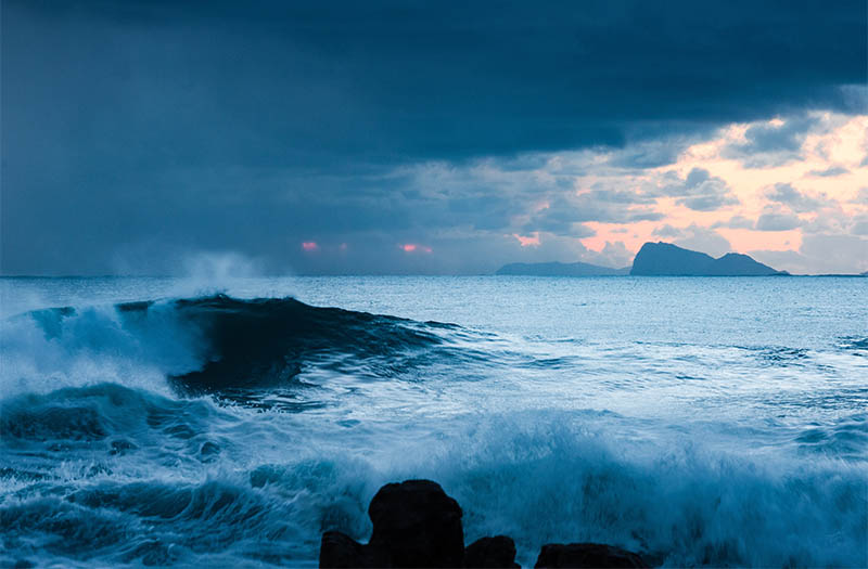A man riding a wave on top of a body of water