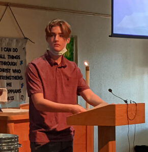 A man standing in front of a table