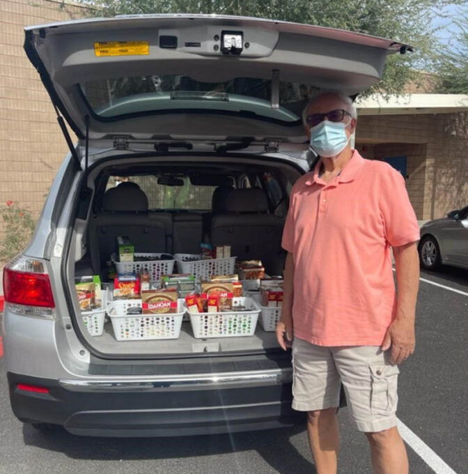 A man standing in front of a car