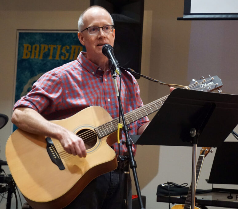 A man holding a guitar
