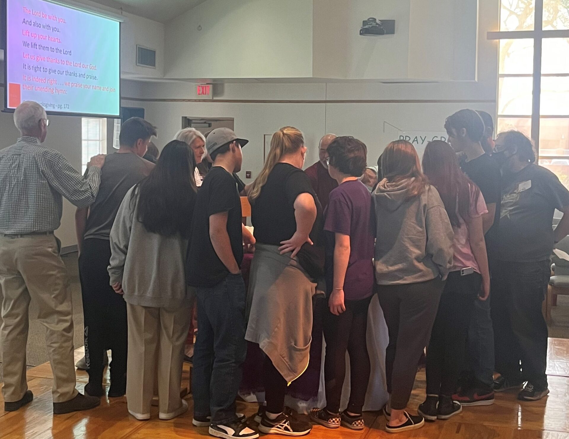 A group of people standing in front of a crowd