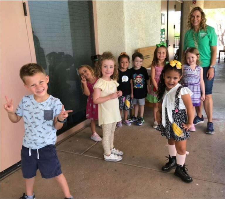 A group of people standing next to a little girl posing for a picture
