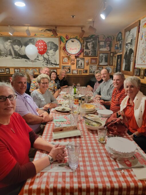Grace Paley et al. sitting at a dinner table