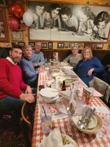A group of people sitting at a table in a restaurant