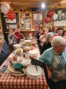 A group of people sitting at a table with food
