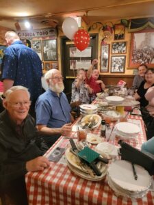 A group of people sitting at a table in a restaurant