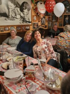 A group of people sitting at a table eating food