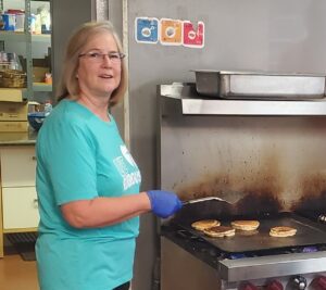 A person standing in a kitchen preparing food