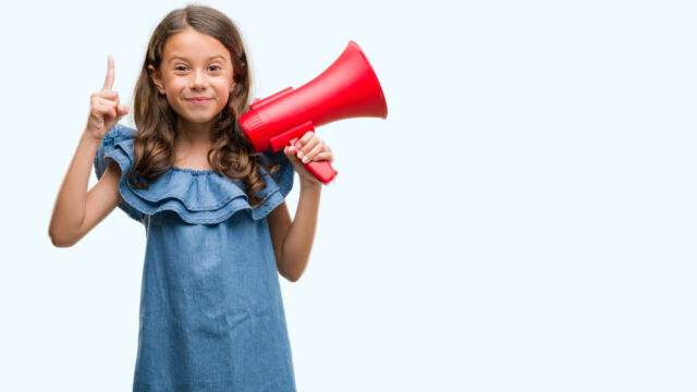 Brunette hispanic girl holding red megaphone surprised with an idea or question pointing finger with happy face, number one