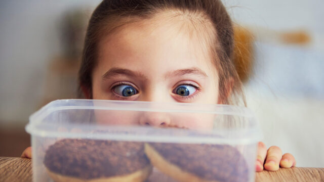 Child looking at delicious donuts
