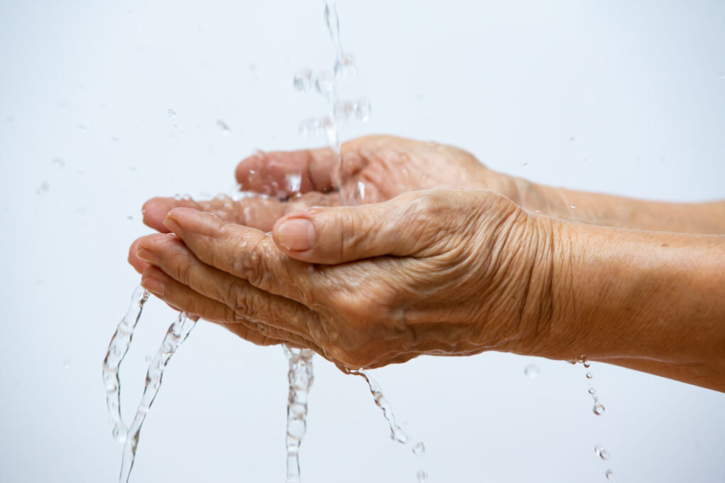 Senior washing hands in white background, Close up and Macro shot, Selective focus.