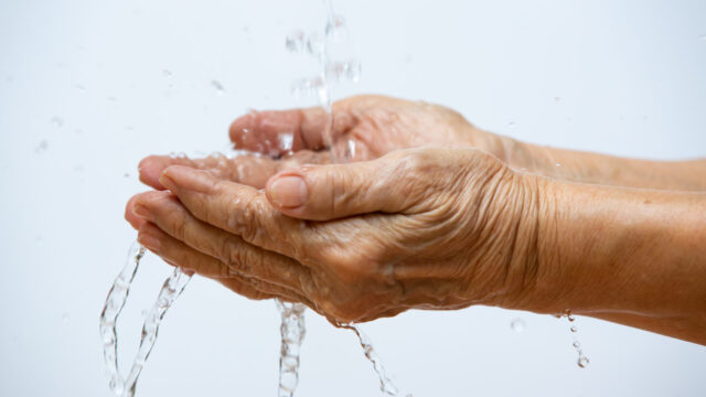 Senior washing hands in white background, Close up and Macro shot, Selective focus.