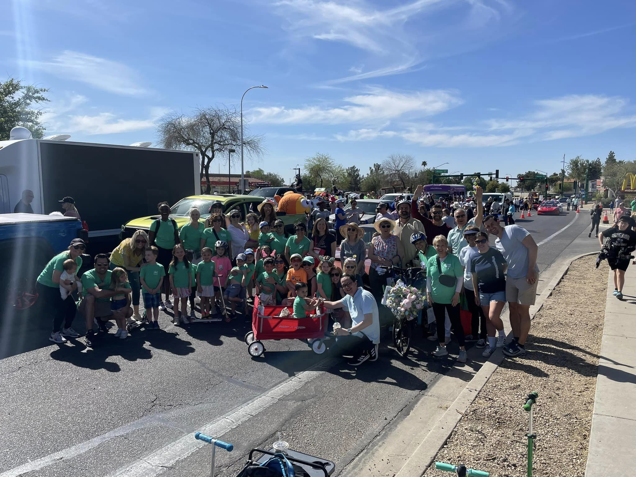 A group of people standing in a parking lot
