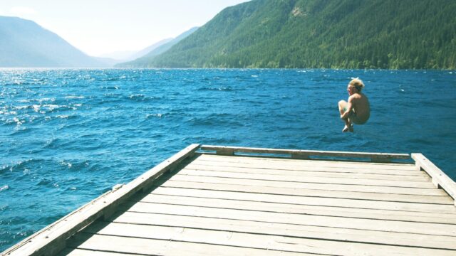 A body of water with a mountain in the background
