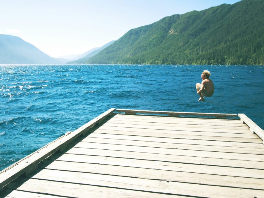 A body of water with a mountain in the background