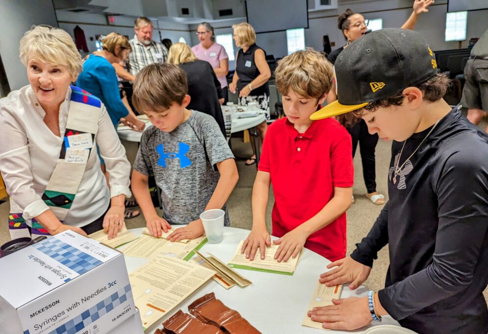A group of people looking at a paper