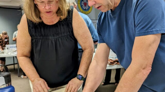 A person cutting a cake