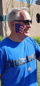 A man wearing sunglasses and a blue shirt