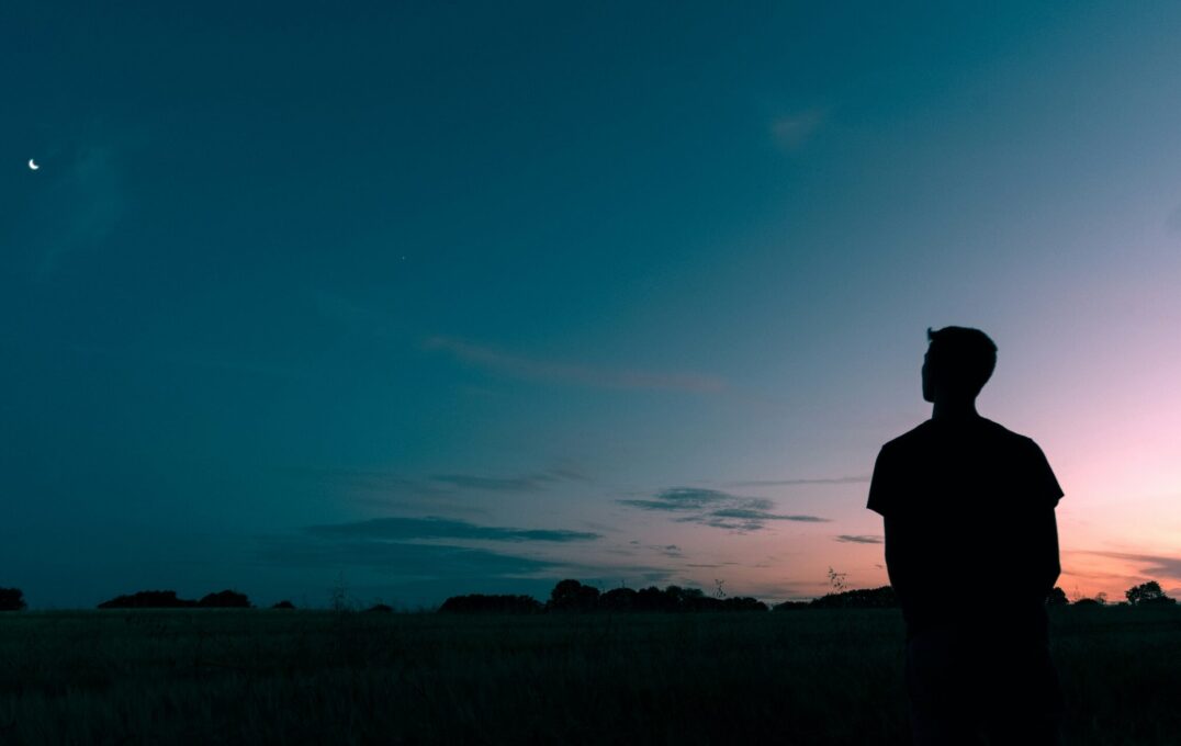 A man standing in front of a sunset