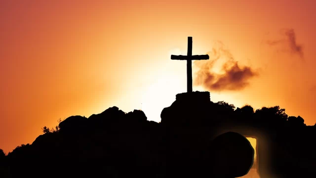 A single cross on a hillside.