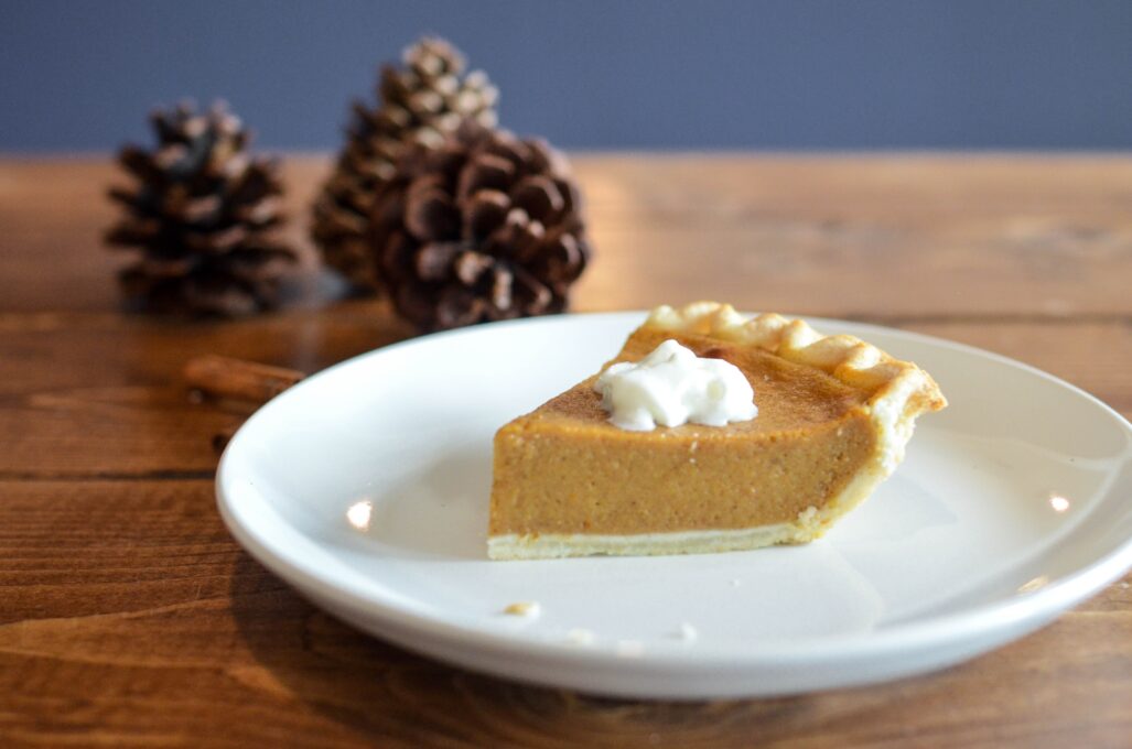 A piece of pumpkin pie on a plate