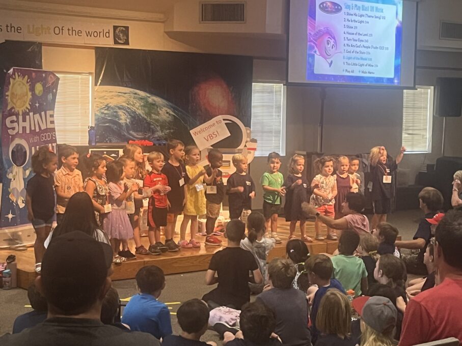 A group of people standing in front of a crowd