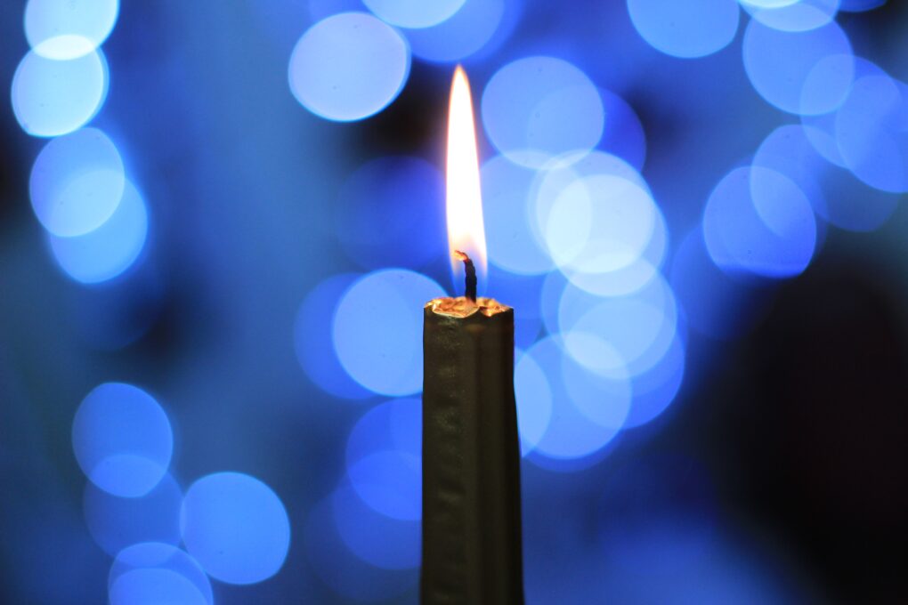 A candle against a blue background