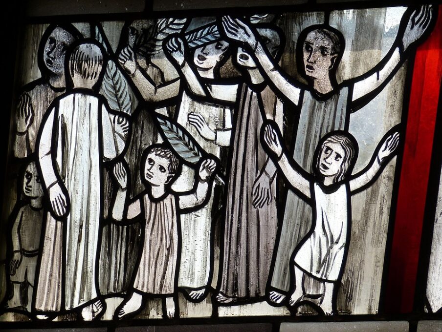 A group of people waving palm branches