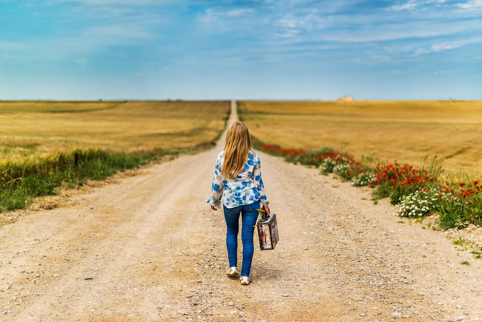 A person riding a bike down a dirt road
